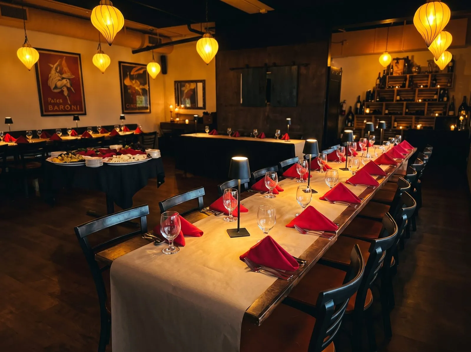 A private event set in the dining room, banquet tables and an antipasti spread beneath the heart-shaped lanterns.