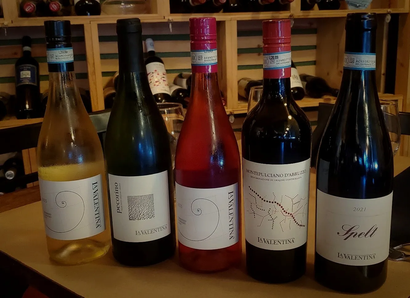 Five Fattoria La Valentina bottles lined up in the wine room at Macaluso’s.