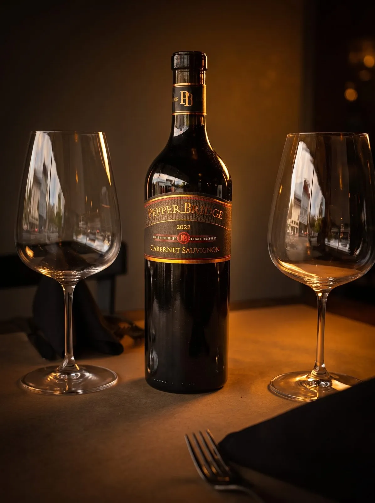 A bottle of Pepper Bridge Cabernet Sauvignon on a candlelit table at Macaluso’s.